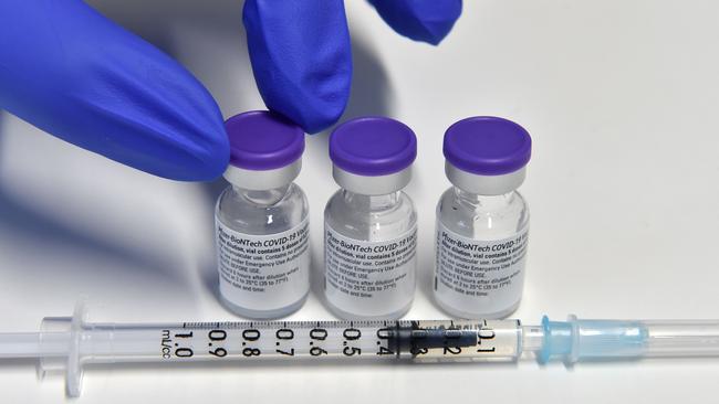 A health worker holds a vial with the Pfizer-BioNTech COVID-19 vaccine. Picture: AFP.