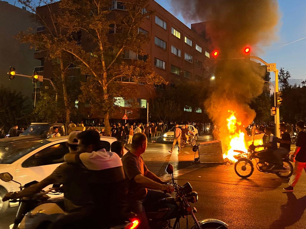 Demonstrators gather around a burning barricade during a protest for Mahsa Amini. Picture: AFP