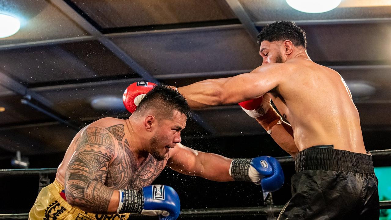 Toowoomba's Herman Ene-Purcell (left) ducks under Will Nasio's shot as they battle for the Australasian heavyweight title at Rumours International.