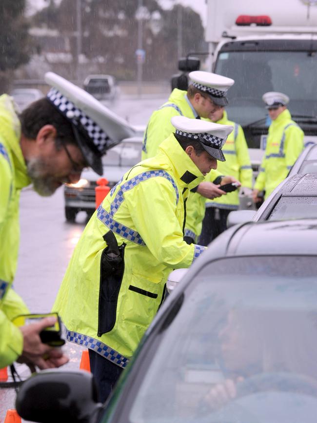 SA police officers during random roadside breath test operation for drug and drunk driving drivers on the Morphett St bridge in Adelaide.