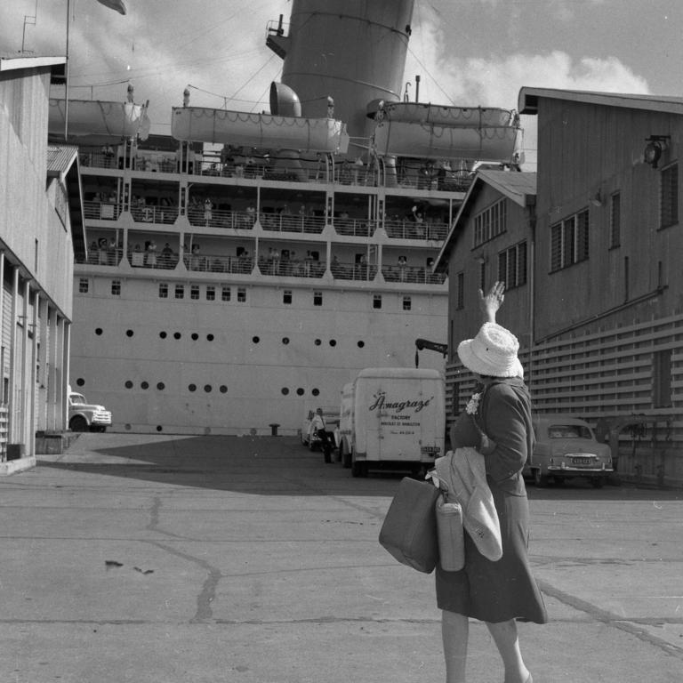 A woman waves to relatives on the Strathmore.