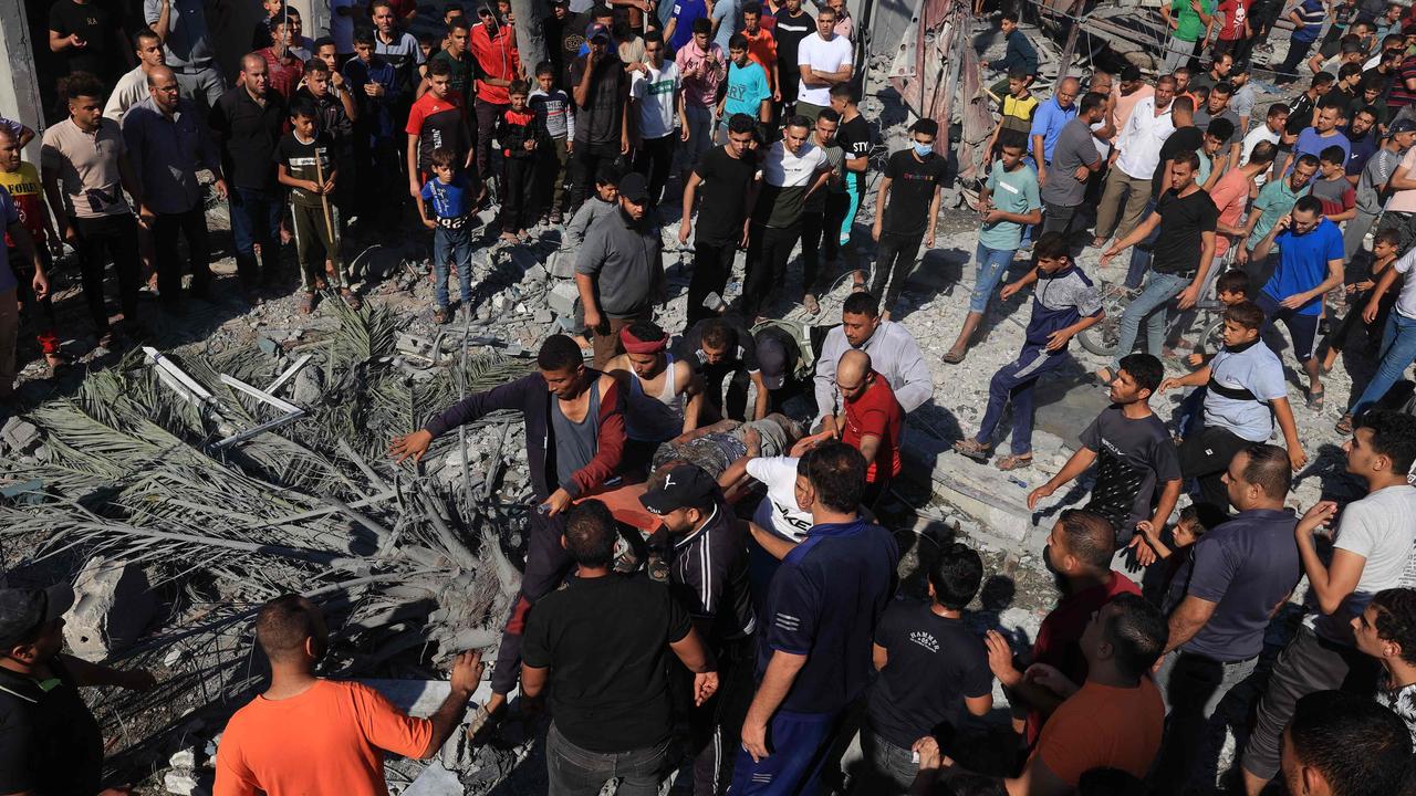 A Palestinian is stretchered away after being pulled out from under the rubble of a building following an Israeli airstrike in Rafah, in the southern of Gaza Strip. Picture: AFP