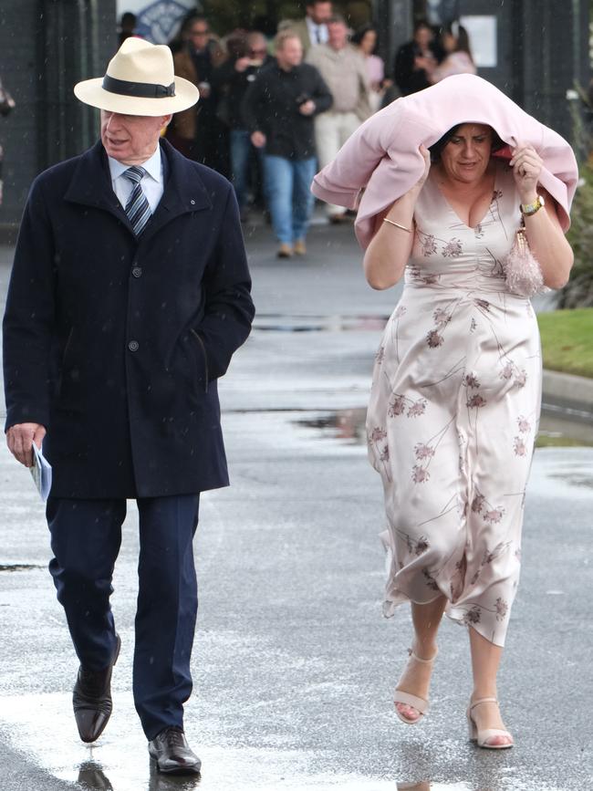 In the aftermath of the Geelong Cup, many were shielding themselves from the wet weather. Picture: Mark Wilson