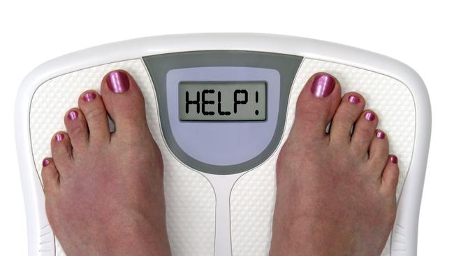 Feet on a bathroom scale with the word help! on the screen. Isolated. Includes clipping path.