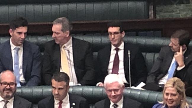 Liberal MPs, back row from left:, Fraser Ellis, Steve Murray, Dan Cregan and Nick McBride sit with Labor MPs in state Parliament after crossing the floor on Tuesday to vote to adjourn the State Government's controversial mining law changes. Picture: Adam Langenberg