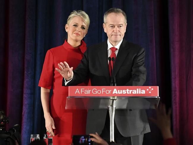 Opposition Labor leader Bill Shorten (R) concedes defeat along with his wife Chloe Shorten (L) after the results of  Australia's general election showing victory for the ruling Coalition Party, in Melboune on May 18, 2019. - Australia's ruling conservative coalition appeared to secure a shock election win on May 18, with the party predicted to have defied expectations and retained power. (Photo by WILLIAM WEST / AFP)