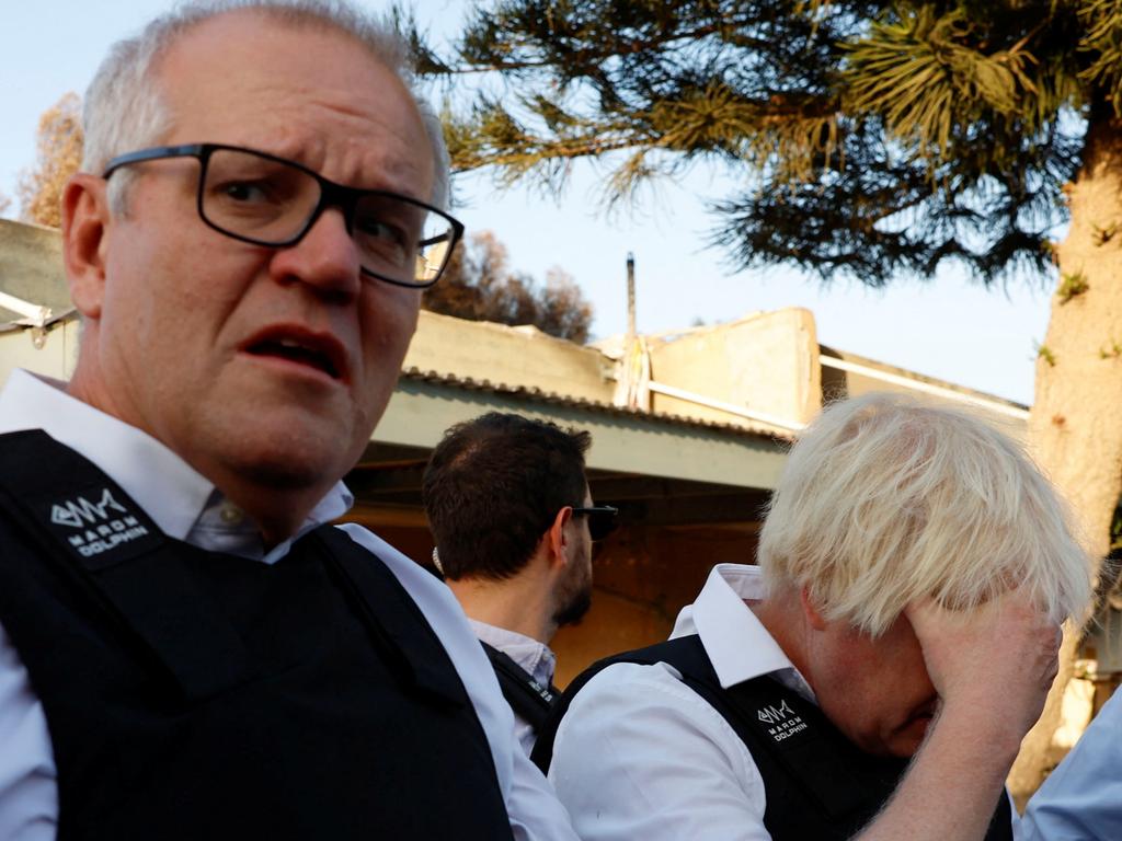 Former British Prime Minister Boris Johnson and former Australian Prime Minister Scott Morrison visit Kibbutz Kfar Aza following the October attack by Hamas gunmen from the Gaza Strip, in southern Israel, November 5, 2023. REUTERS/Evelyn Hockstein