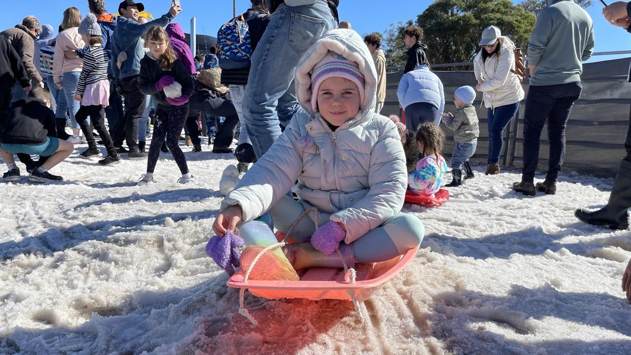 Hampton girl Ella Wood (7) slides down the snowfield hill on a toboggan at the 2021 Snowflakes in Stanthorpe festival. Photo: Madison Mifsud-Ure / Stanthorpe Border Post