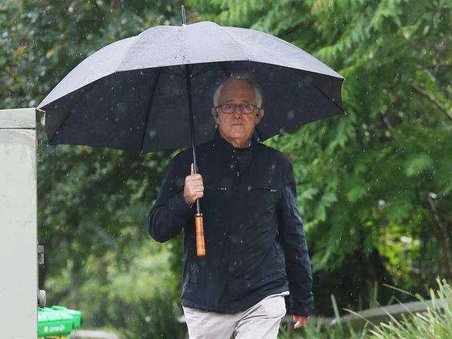 Former PM Malcolm Turnbull walks in the rain near his home at Point Piper, Sydney. Picture: John Feder/The Australian.