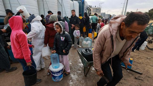 Palestinians line up to fill their containers with water in Rafah on the southern Gaza Strip. Picture: AFP