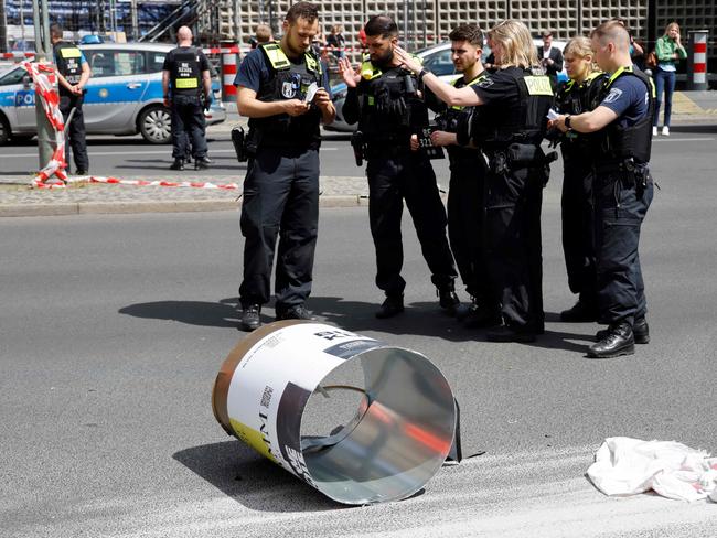 Police officers inspect the site where a car ploughed into a crowd in Berlin. Picture: AFP