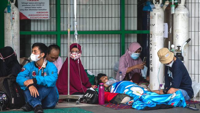 People wait for admission outside the emergency ward of a hospital tending to Covid-19 coronavirus patients in Surabaya, Indonesia. Picture: AFP