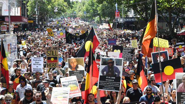 Invasion Day protesters are seen during Australia Day celebrations in Melbourne, Saturday, January 26, 2019. (AAP Image/James Ross) NO ARCHIVING