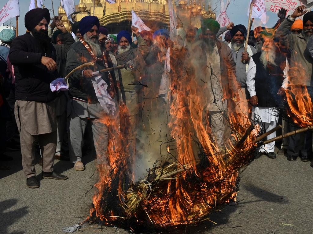 Farmers shout slogans as they burn an effigy of Indian Prime Minister Narender Modi and Finance minister Nirmala Sitharaman during a protest in February 2023.