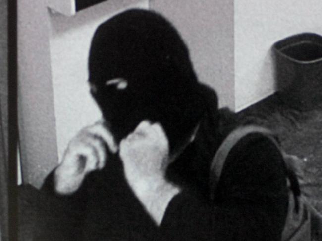 The notorious Adelaide Hills bank robbing bicycle bandit, wearing a balaklava and carrying a gun, captured on security cameras.