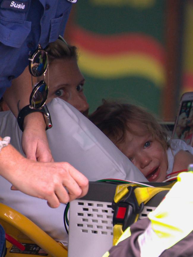 The mother comforts her little girl as paramedics prepare them for the trip to hospital. Picture: OnScene Bondi