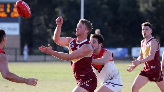 NFL: Tom Keys fires off a handball for Lower Plenty. Picture: George Sal