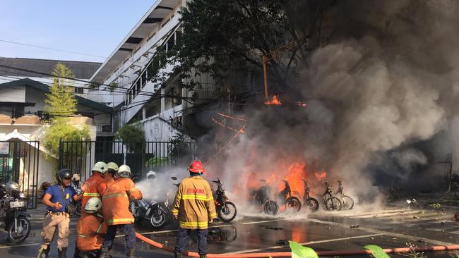 Firefighters outside the Surabaya Centre Pentecostal Church after one of the attacks. Picture: via AFP