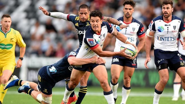 Rebels five-eighth Matt Toomua looks to pass under pressure against the Highlanders in Dunedin. Picture: AAP