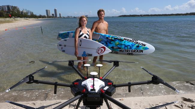 Champion surfer Nikki Van Dijk and Ironman TJ Hendy take part in the 5G drone demonstrations. Picture Glenn Hampson