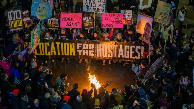 Protestors in tel Aviv chant and call for the ceasefire deal to continue while holding a banner that reads ‘relocation for the hostages’. Picture: Getty Images