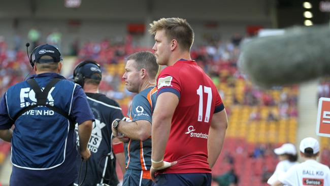 Reds hold on in tight affair                     Impressive young Queensland Reds prop Harry Hoopert looks on from the sidelines.