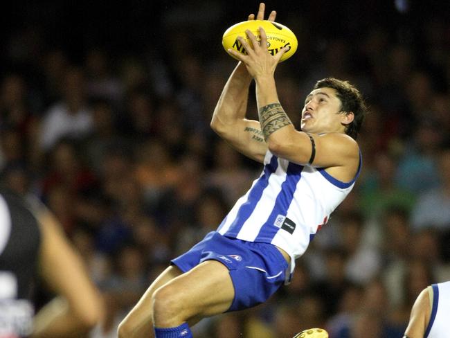 Kangaroo Aaron Edwards flies high against Essendon in 2013.