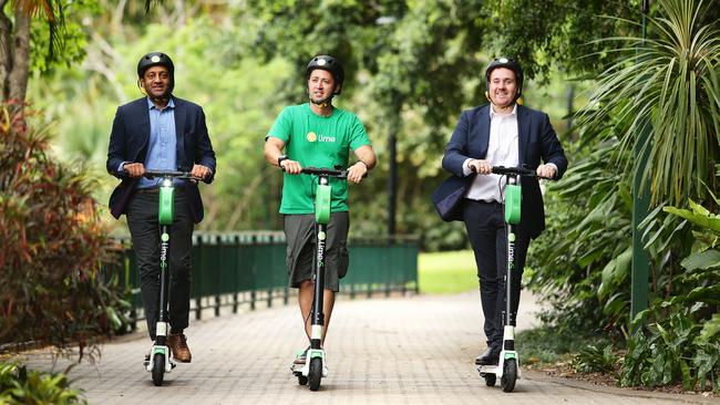 Mayank Mittal, Vinicius Machado Campos and Mitchell Price, at Brisbane Botanical Gardens, launched Lime electric scooters in Brisbane. Picture: AAP/Claudia Baxter