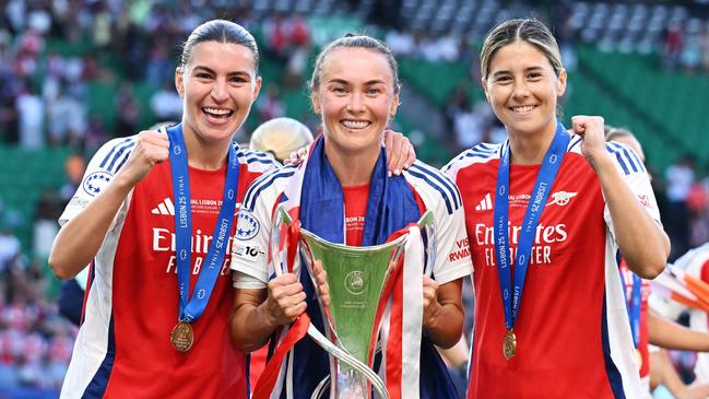 Steph Catley, Caitlin Foord and Kyra Cooney-Cross of Arsenal celebrate with the UEFA Women's Champions League trophy after their team's victory in the UEFA Women's Champions League final match between Arsenal WFC and FC Barcelona Picture: David Price/Arsenal FC via Getty Images
