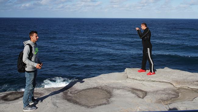 Visitors photograph the views along the Bondi to Coogee Walk. Picture: Danny Aarons