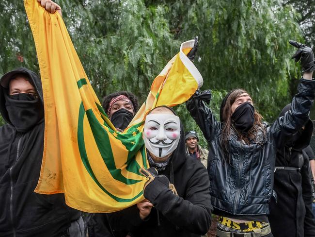 United Patriot Front supporters clutch their flag while rallying in Coburg. Picture: Jake Nowakowski