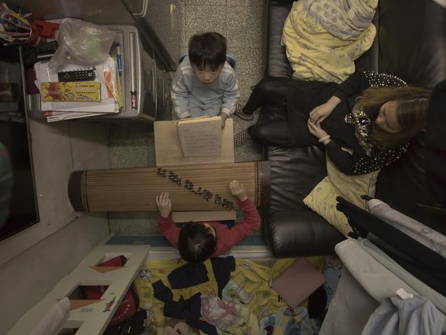 Li Suet-wen is pictured with her two children in their cramped home. Picture: Kin Cheung/AP