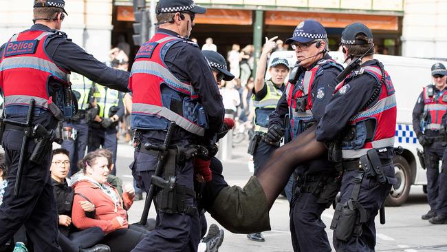 Police forcibly remove an animal rights protester. Picture: AAP Image/Ellen Smith