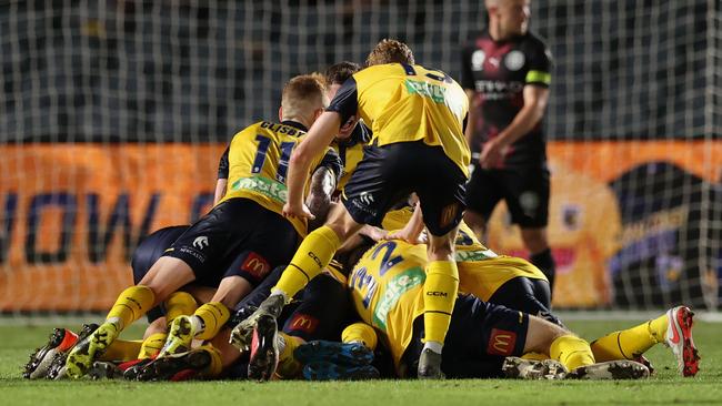 Danny De Silva of the Mariners celebrates the winner with teammates against Melbourne City FC Picture: Getty Images