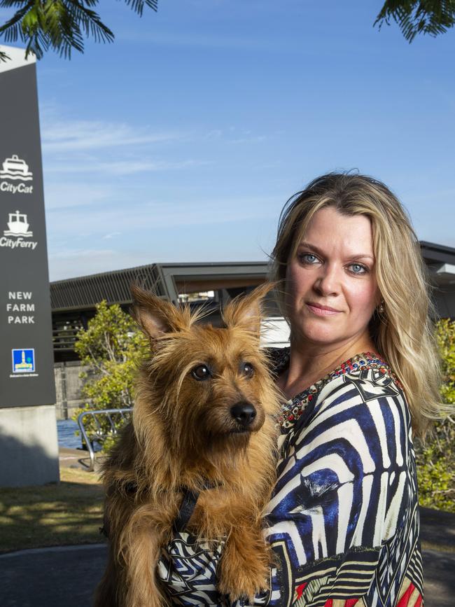 New Farm resident Annie Boxall poses for a photograph at New Farm Ferry Terminal with her dog Banjo, Saturday, January 19, 2019 (AAP Image/Richard Walker)