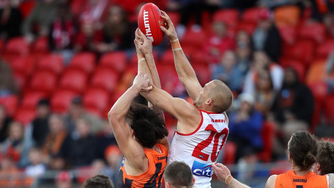 GWS’ Jake Stein pulls the arm of Sydney’s Sam Reid in the final moments of the Sydney Derby. Photo: Phil Hillyard