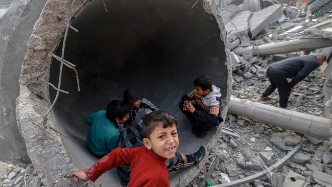 Children play in one of the fallen domes of the al-Faruq mosque, levelled by Israeli bombardment in Rafah at the weekend. Picture: AFP)