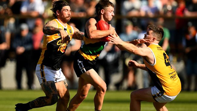 Jake Aarts of the Tigers is tackled by Kyle Hutchison (left) and Lachlan Wallace of the Stonecats during the 2023 MPFNL Division 1 grand final. (Photo by Josh Chadwick)