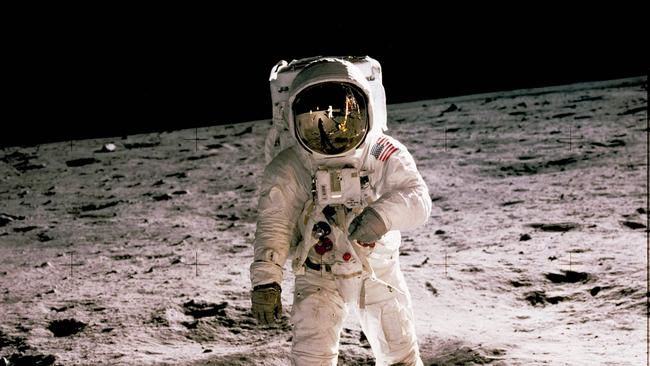 A photo taken by Neil Armstrong (reflected in the helmet’s visor) shows Edwin ‘Buzz’ Aldrin walking on the moon on July 20, 1969. Picture: AFP