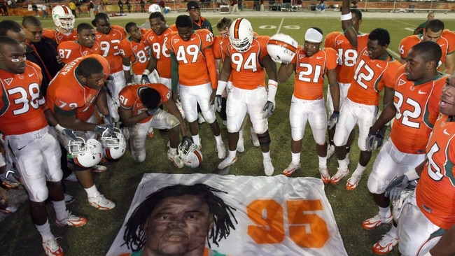 Rashaun Jones far left, with teammates over a mural of Bryan Pata. Photo: Doug Benc, Getty.