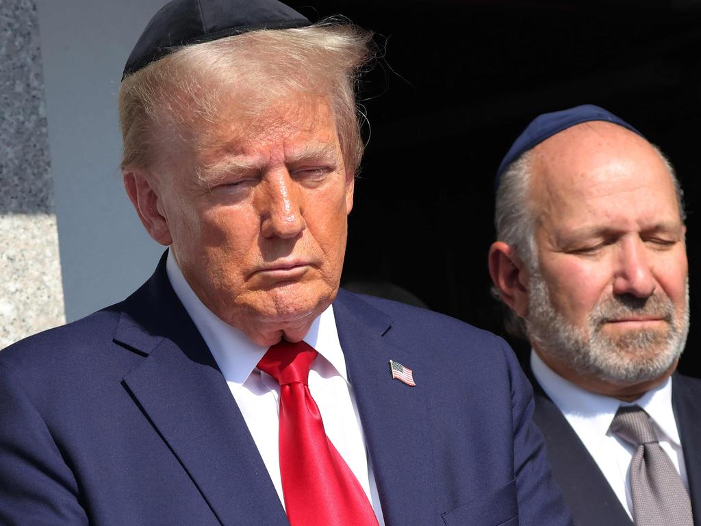 NEW YORK, NEW YORK - OCTOBER 07: Republican presidential nominee, former U.S. President Donald Trump, prays at Ohel Chabad Lubavitch on October 07, 2024 in New York City. Trump commemorated the one-year anniversary of October 7th by visiting to Ohel Chabad Lubavitch, the final resting place of Rabbi Menachem M. Schneerson the Rebbe, with the family of Edan Alexander, who was taken hostage by Hamas on October 7th, in attendance. On October 7, the Palestinian militant group Hamas launched a surprise attack on Israel from Gaza by land, sea, and air, killing more than 1,200 people and taking Israeli soldiers and civilians hostage. To date, there are over 90 people still being held hostage by Hamas.   Michael M. Santiago/Getty Images/AFP (Photo by Michael M. Santiago / GETTY IMAGES NORTH AMERICA / Getty Images via AFP)