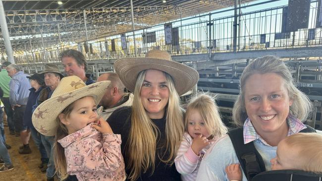 Winnie Mann, 3, April Mann, Sybil Miller, 2, Fleur Mann and George Miller, 10 months, at the Mortlake store cattle sale on Thursday.