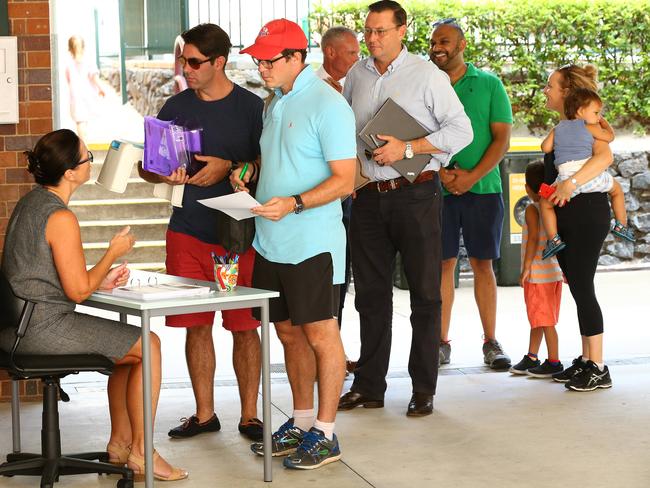 Parents lining up last year in an attempt to secure a spot for their kids. Picture: Liam Kidston