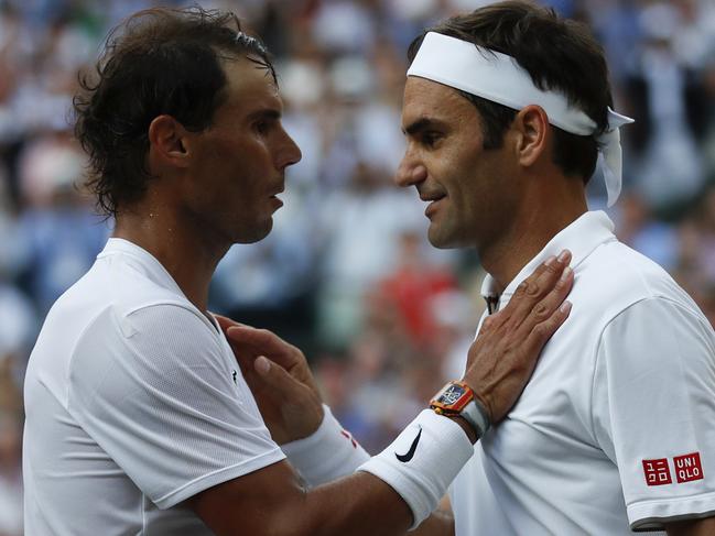 LONDON, ENGLAND - JULY 12: Roger Federer of Switzerland and Rafael Nadal of Spain embrace at the net after their Men's Singles semi-final match during Day eleven of The Championships - Wimbledon 2019 at All England Lawn Tennis and Croquet Club on July 12, 2019 in London, England. (Photo by Clive Brunskill/Getty Images)