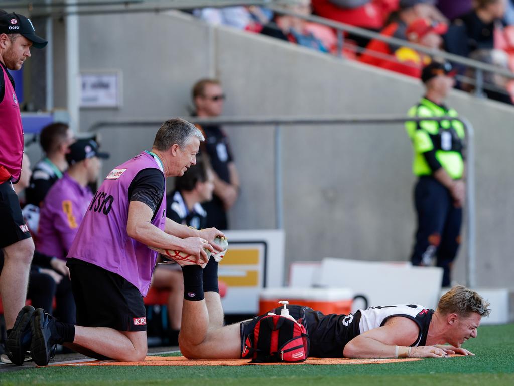 Todd Marshall being assessed by a club physio during the Power’s loss to the Crows. Picture: Russell Freeman/AFL Photos via Getty Images.