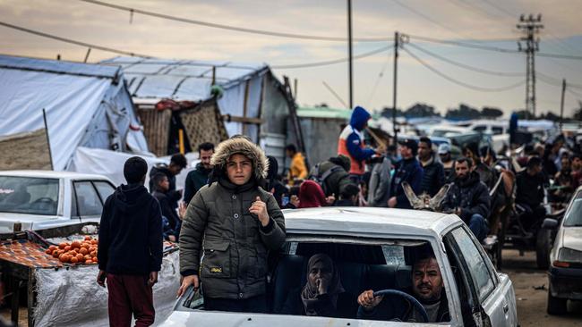 Palestinians use a damaged vehicle as they flee Khan Yunis in the southern Gaza Strip. Picture: AFP