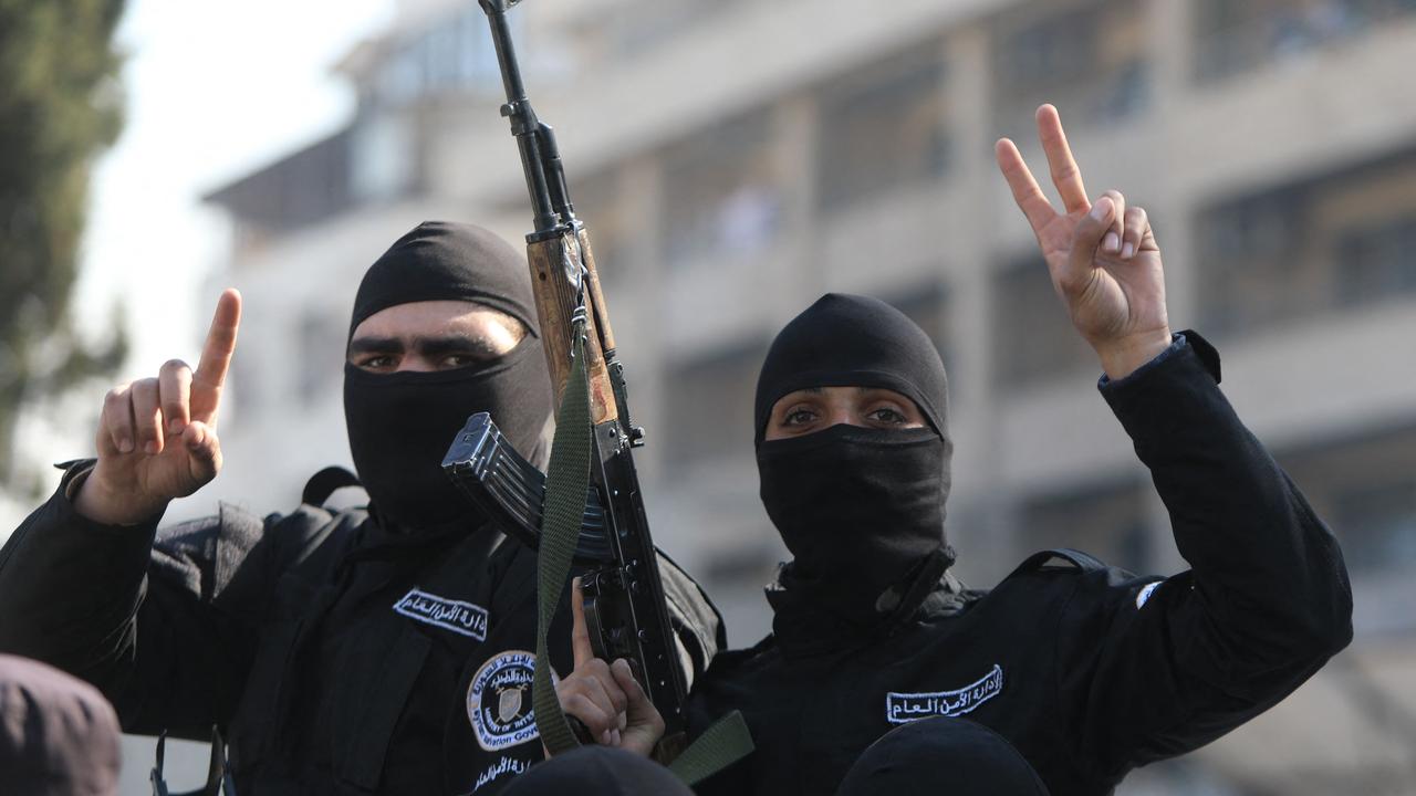 Security forces reporting to Syria's transitional government flash the V-sign for victory as they patrol the streets of Dummar, a suburb of the Syrian capital Damascus. Picture: Bakr Alkasem/AFP