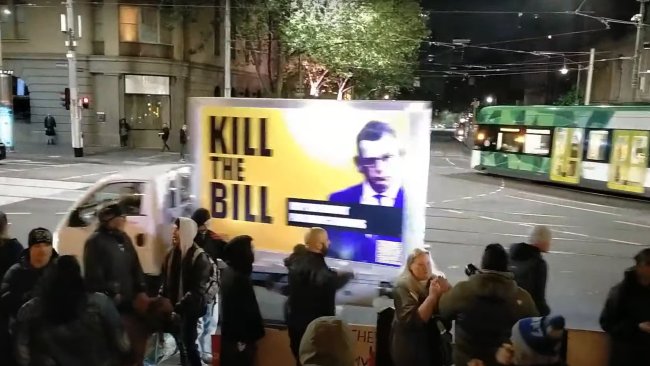 A truck hoisting a billboard emblazoned with a picture of Premier Daniel Andrews and the words "kill the bill" seen outside Parliament House on Monday night. Picture: Twitter 