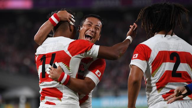 Japan's wing Kotaro Matsushima (L) is congratulated after scoring a try during the Japan 2019 Rugby World Cup Pool A match between Japan and Russia at the Tokyo Stadium in Tokyo on September 20, 2019. (Photo by CHARLY TRIBALLEAU / AFP)