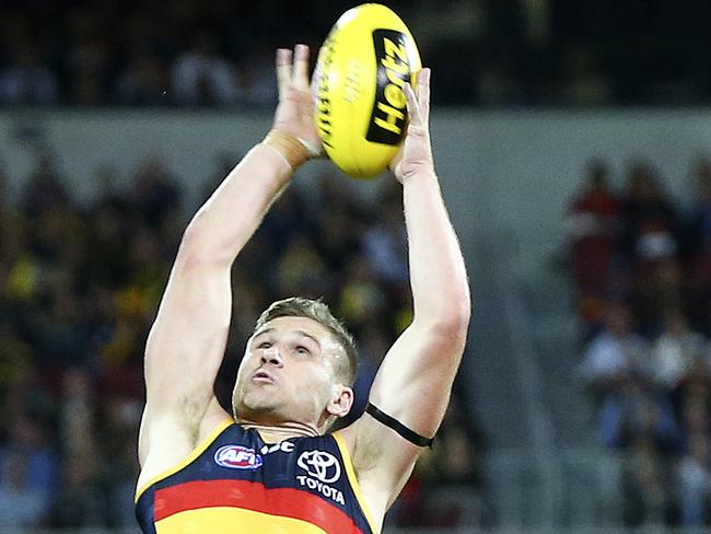 29/03/18 - AFL - Adelaide Crows v Richmond at Adelaide Oval. Rory Laird marks in front of Dustin Martin and Tom Doedee. Picture SARAH REED